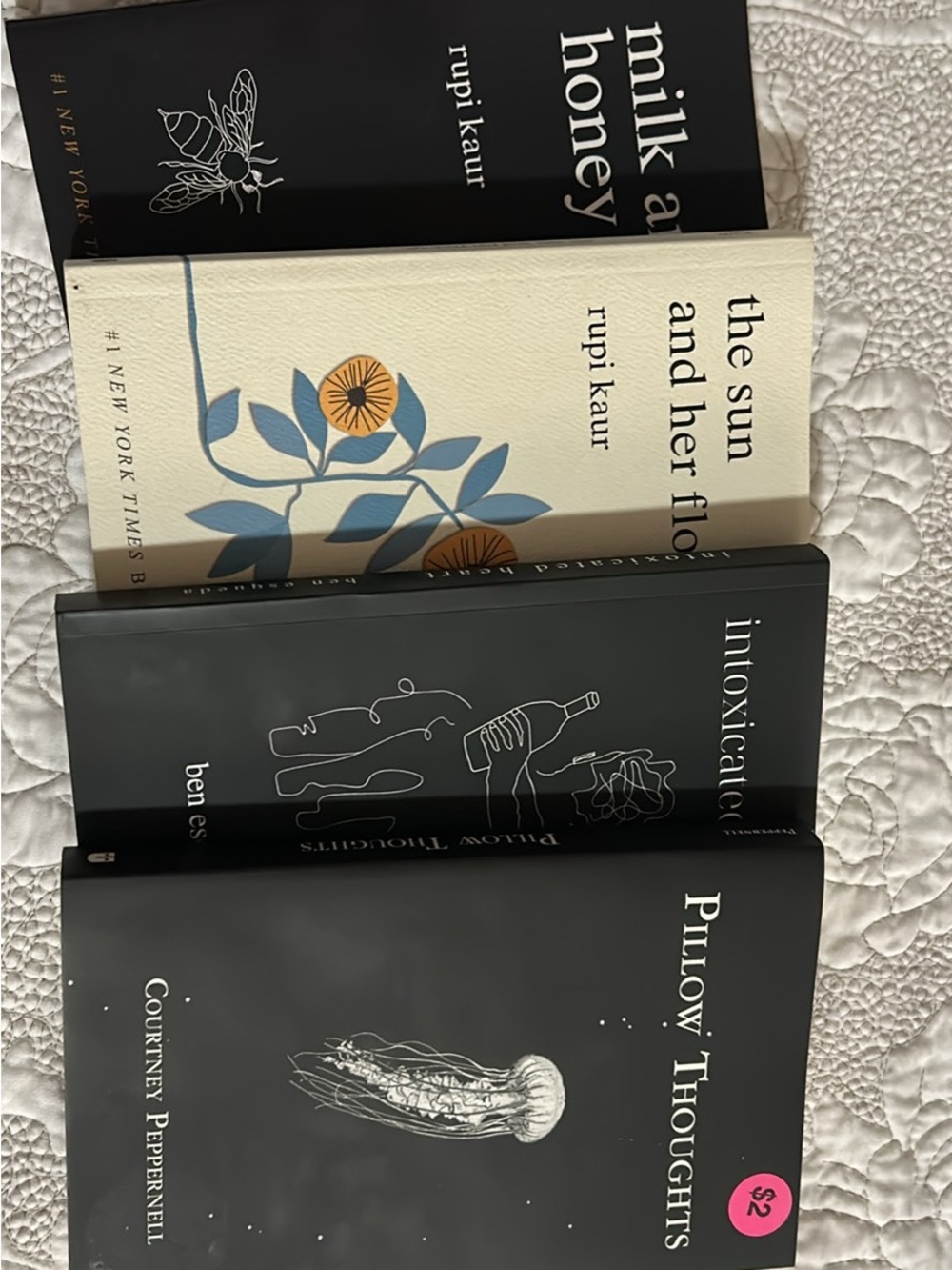 Collection of Decorative Paperback Books in Black, Cream, and Blue